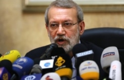 FILE - In this file photo taken Feb. 17, 2020, Iranian Parliament Speaker Ali Larijani gives a press conference at the Iranian Embassy in Beirut.
