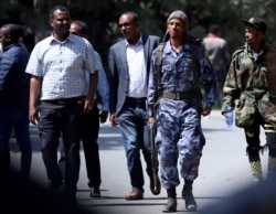 A federal police officer walks outside Jawar Mohammed's house, an Oromo activist and leader of the Oromo protest, in Addis Ababa, Ethiopia, Oct. 23, 2019.