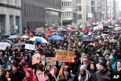FILE - Protesters hold banners as they march during a "Rise for the Climate" demonstration in Brussels, Belgium, Jan. 27, 2019.