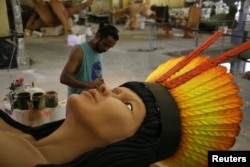 A worker from the Imperatriz Leopoldinense samba school prepares part of a carnival float at the school's carnival production headquarters in Rio de Janeiro, Brazil, Feb. 9, 2017.