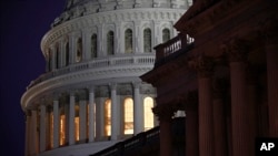 FILE - Light shines on the U.S. Capitol dome on Capitol Hill in Washington, Dec. 13, 2019.