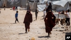 Children run in al-Hol camp, which houses families of members of the Islamic State group in Hasakeh province, Syria, April 19, 2023.