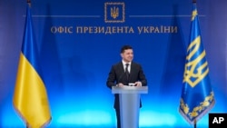 FILE - In this handout photo released by the Ukrainian Presidential Press Office, Ukrainian President Volodymyr Zelenskiy speaks at a ceremony in Kyiv, Ukraine, Feb. 13, 2020.