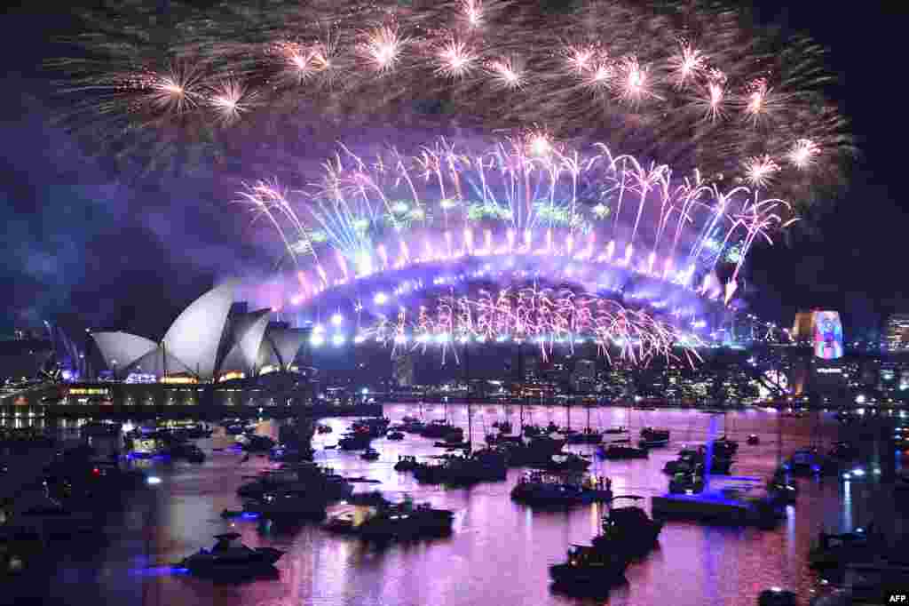 New Year's Eve fireworks burst over Sydney's famous Harbour Bridge and Opera House in Australia, during the fireworks show, Jan. 1, 2019.