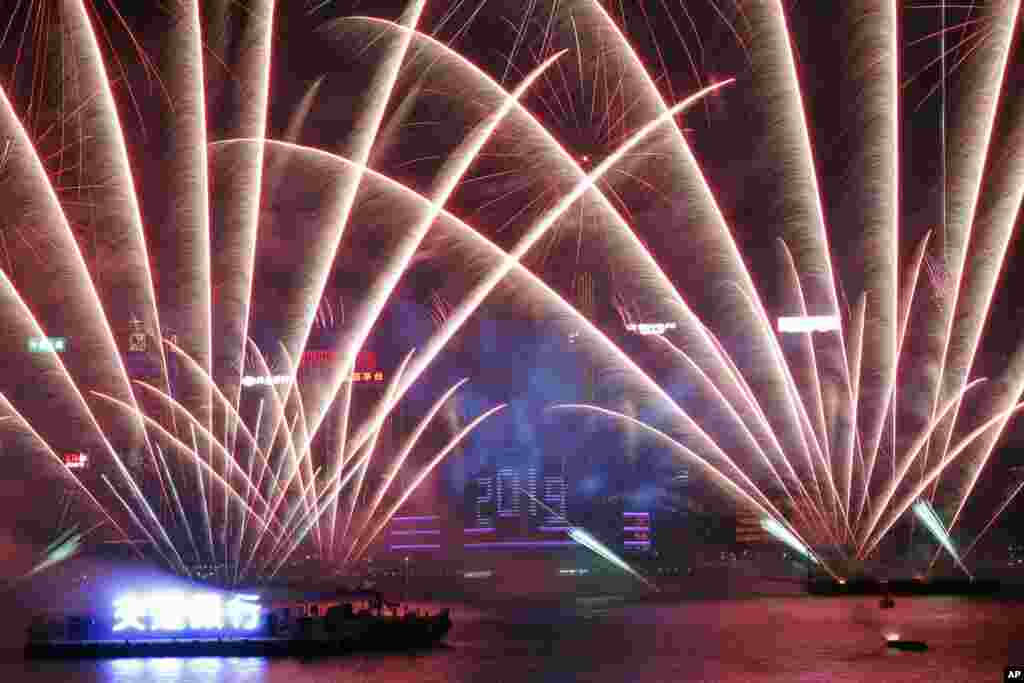 Fireworks explode over Victoria Harbor during New Year's Eve to celebrate the start of year 2019 in Hong Kong, Jan. 1, 2019.
