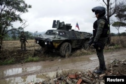 Colombian soldiers stand guard during a military operation at the border with Venezuela in Cucuta, Feb. 13, 2018.