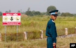 FILE - A Vietnamese soldier stands guard at the dioxin contaminated area while U.S. Defense Secretary Jim Mattis visits Bien Hoa air base in Bien Hoa, outside Ho Chi Minh City, Vietnam, Oct. 17, 2018. (Kham/Pool Photo via AP)