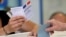 FILE - A man casts his ballot in parliamentary elections at a polling station in Marseille, southern France, June 18, 2017. 