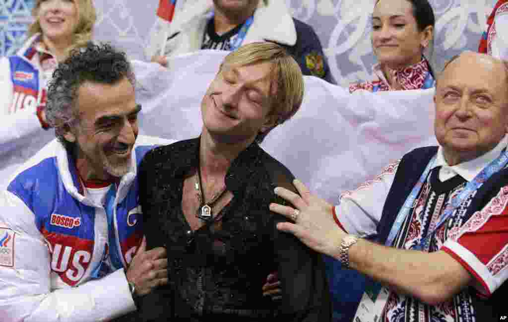 Evgeni Plushenko of Russia, center, reacts after competing in the men's team figure skating competition at the Iceberg Skating Palace, Sochi, Russia, Feb. 9, 2014. 