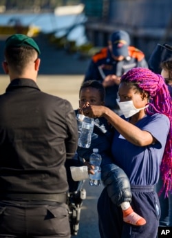 Migrants disembark from the German humanitarian ship Rise Above docked in the southern Italian port town of Reggio Calabria, Tuesday, Nov. 8, 2022.