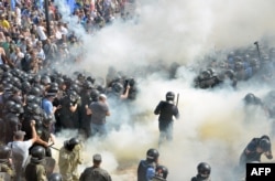Smoke rises near the parliament building in Kiev as activists of radical Ukrainian parties, including the Ukrainian nationalist party Svoboda (Freedom), clash with police officers on August 31, 2015.