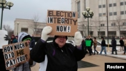 FILE - Members of the Green Party rally in support of continuing the recount of the U.S. presidential ballots in Lansing, Mich., Dec. 8, 2016.