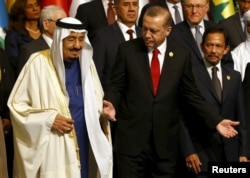 FILE - Turkish President Recep Tayyip Erdogan and King Salman of Saudi Arabia are pictured during a photo session at the Organization of Islamic Cooperation's summit in Istanbul, April 14, 2016.