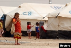Displaced children, who fled from the Islamic State violence, gather at a refugee camp in the Makhmour area near Mosul, Iraq, June 17, 2016.