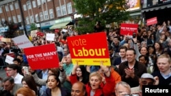 Supporters watch Jeremy Corbyn the leader of Britain's opposition Labour Party, as he speaks at an election campaign event in Harrow, June 7, 2017.