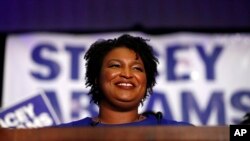 Democratic candidate for Georgia Governor Stacey Abrams smiles as she speaks during an election-night watch party, May 22, 2018, in Atlanta. 