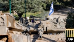 An Israeli army Merkava main battle tank is deployed by the concrete border wall at a position along Israel's northern border with Lebanon on Feb. 18, 2025.