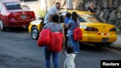 Migrant women who were deported from the U.S. leaves the Integral Assistance Center for Migrants in San Salvador, El Salvador, Feb. 5, 2020. 
