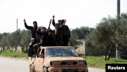 A father's day card sits among flowers left for the victims of the Grenfell apartment tower fire in North Kensington, London.