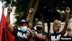 People react while gathering for a vigil, following the police shooting of Jacob Blake, a Black man, in Kenosha, Wisconsin, Aug. 28, 2020. 