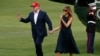 President Donald Trump and first lady Melania Trump hold hands and wave at supporters as they walk across the South Lawn on their return to the White House, June 7, 2019, in Washington.