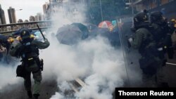 Demonstrators are caught in tear gas during a protest against the Yuen Long attacks in Yuen Long, New Territories, Hong Kong, July 27, 2019.