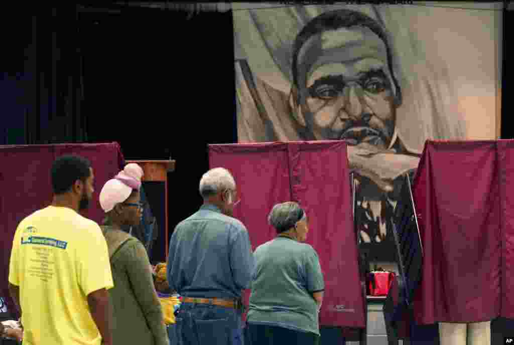 People wait in line to cast their vote on Election Day at the Martin Luther King, Jr. Charter School in the Lower 9th Ward of New Orleans, Nov. 8, 2016. 