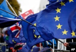 The EU and British flags are seen at the demonstrations area near the parliament building in London, Britain, Jan. 16, 2019.