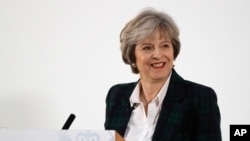 Britain's Prime Minister Theresa May smiles after she delivers a speech on leaving the European Union at Lancaster House in London, Jan. 17, 2017.