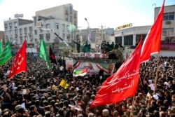 In this photo provided by he Iranian Students News Agency, ISNA, flag-draped coffins of Gen. Qassem Soleimani and his comrades are seen during a tribute in the southwestern city of Ahvaz, Iran, Jan. 5, 2020.