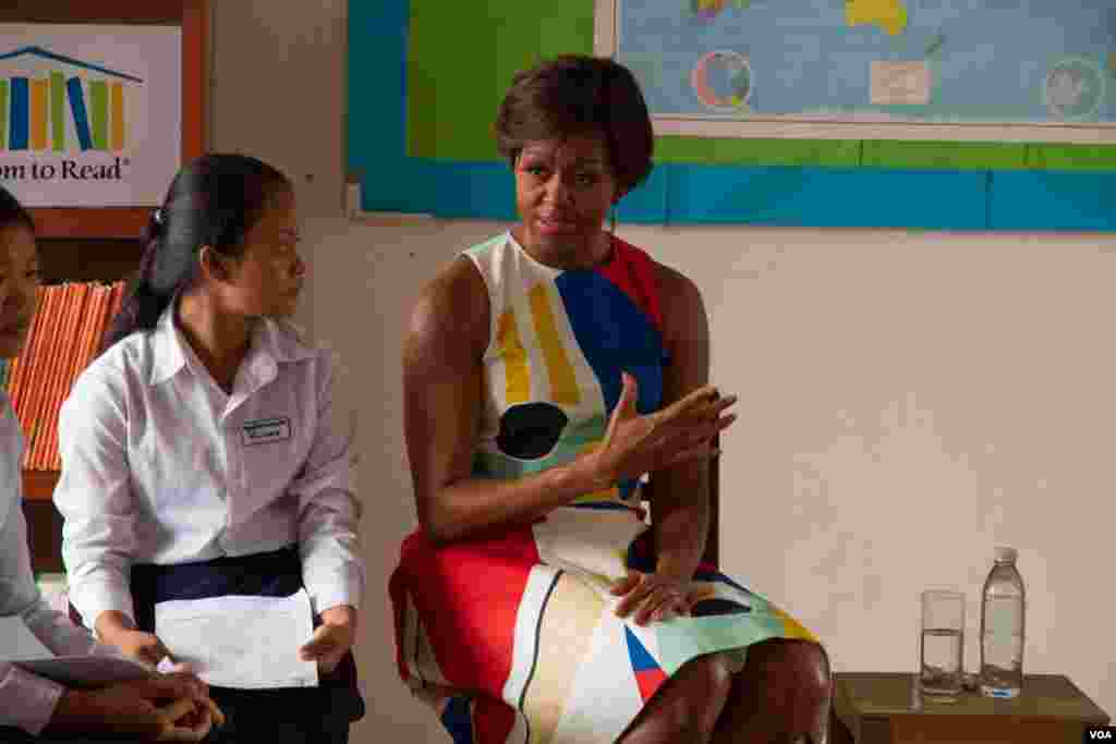 Michelle Obama speaks with a girl at Hun Sen Prasat Bakong Hight School, outside Siem Reap, March 21, 2015.