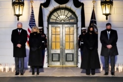 President Joe Biden, First Lady Jill Biden, Vice President Kamala Harris and her husband Doug Emhoff, bow their heads during a ceremony to honor the 500,000 Americans that died from COVID-19, at the White House, Monday, Feb. 22, 2021, in Washington. (AP Photo/Evan Vucci)