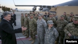 Ukraine's President Petro Poroshenko speaks with U.S. servicemen who delivered counterbattery radars for the Ukrainian army in Lviv, Ukraine, Nov. 14, 2015.