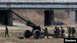 South Korean soldiers of an artillery unit take part in an artillery drill with 155mm Towed Howitzers as part of the annual joint military exercise "Foal Eagle" by the U.S. and South Korea, near the demilitarized zone (DMZ) which separates the two Korea, 