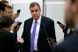 Sen. Mark Warner, D-Va., talks to reporters on Jan. 28, 2020 on Capitol Hill in Washington.