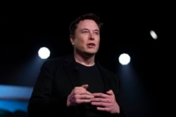 FILE - Tesla CEO Elon Musk speaks before unveiling the Model Y at the company's design studio in Hawthorne, California, March 14, 2019.