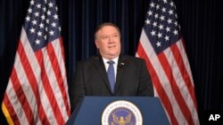 U. S. Secretary of State Mike Pompeo listens to a 