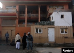 Afghan policemen keep watch outside the house of an Afghan member of parliament that was attacked by Taliban, Dec. 21, 2016, in Kabul, Afghanistan.