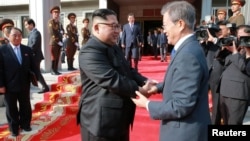 South Korean President Moon Jae-in shakes hands with North Korean leader Kim Jong Un during their summit at the truce village of Panmunjom, North Korea, May 27, 2018.