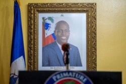 A picture of slain Haitian President Jovenel Moise hangs on a wall before a news conference by acting Prime Minister Claude Joseph, in Port-au-Prince, Haiti, July 13, 2021.