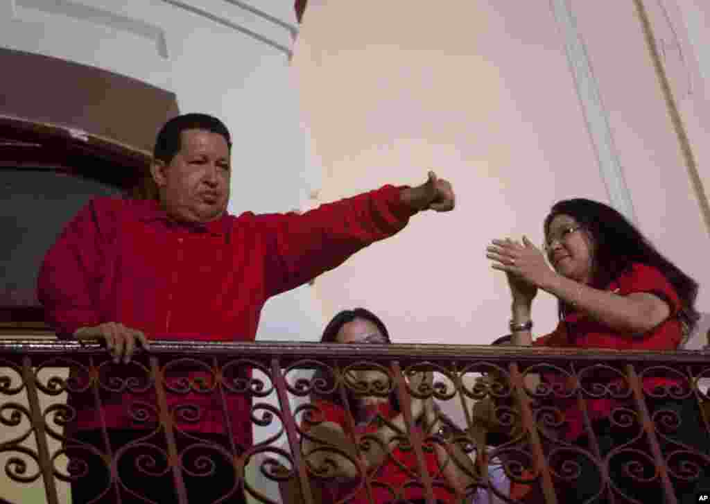 Venezuela's President Hugo Chavez greets his supporters from the Miraflores presidential palace balcony in Caracas, Venezuela.