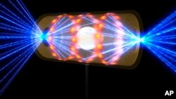This illustration provided by the National Ignition Facility at the Lawrence Livermore National Laboratory depicts a target pellet inside a hohlraum capsule with laser beams entering through openings on either end. The beams compress and heat the target t