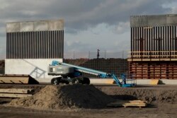 The first panels of levee border wall are seen at a construction site along the U.S.-Mexico border, Thursday, Nov. 7, 2019, in Donna, Texas. The new section, with 18-foot tall steel bollards atop a concrete wall, will stretch approximately 8 miles.