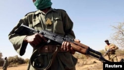 FILE - Malian soldiers patrol while training with U.S. soldiers in Gao, eastern Mali, Nov. 13, 2006.