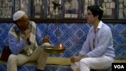 Carlos Basteiro Bertoli talks with a fellow Jewish pilgrim at at the Ghriba synagogue in Djerba, Tunisia. (L. Bryant/VOA)