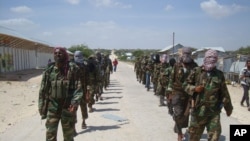  FILE - Members of Somalia's al-Shabab militant group patrol on the outskirts of Mogadishu, March, 5, 2012. Citing senior U.S. officials, The New York Times reported Monday the administration has deemed al-Shabab to be part of the armed conflict that Congress authorized against the perpetrators of the September 11, 2001 attacks.