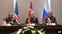 FILE - Turkey's Chief of Staff Gen. Hulusi Akar, center, U.S. Chairman of the Joint Chiefs of Staff Gen. Joseph Dunford, left, and Russia's Chief of Staff Gen. Valery Gerasimov attend a meeting in the Mediterranean coastal city of Antalya, Turkey, March 7, 2017.