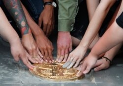 FILE - Pro-democracy student leaders install a plaque declaring 'This country belongs to the people' at the Sanam Luang field during a protest in Bangkok, Thailand, Sept. 20, 2020.