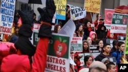 FILE - Teachers and students rally in the steps in front of Hamilton High School in Los Angeles, Jan. 16, 2019.