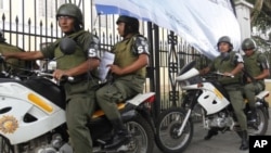 Soldiers patrol outside a polling station in Guatemala City, September 10, 2011.
